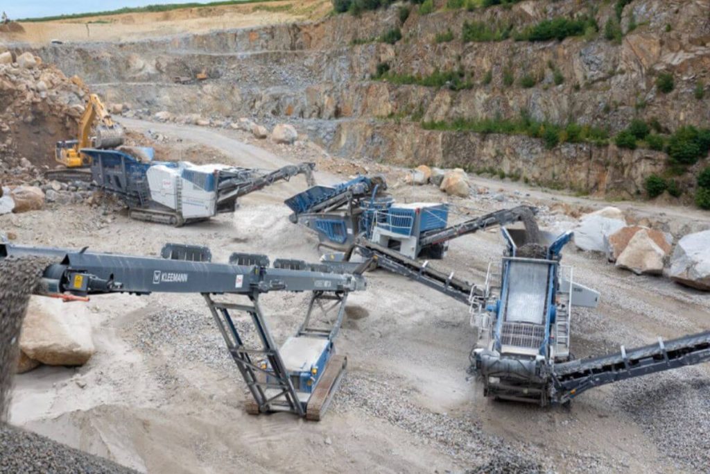 Multiple mining equipment units at a mining site, positioned and ready for large-scale industrial deployment.