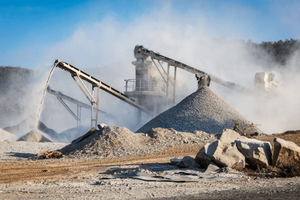 Crushing site with heavy equipment operating for large-scale material processing, aggregate production, and mining or construction operations.