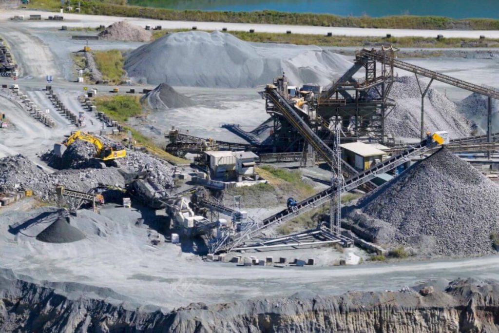 Stone crusher operating in a quarry site for efficient rock crushing, aggregate production, and large-scale material processing operations.