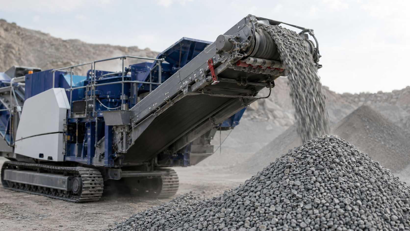 Close-up of cone crusher discharge conveyor producing graded aggregate for quarry operations