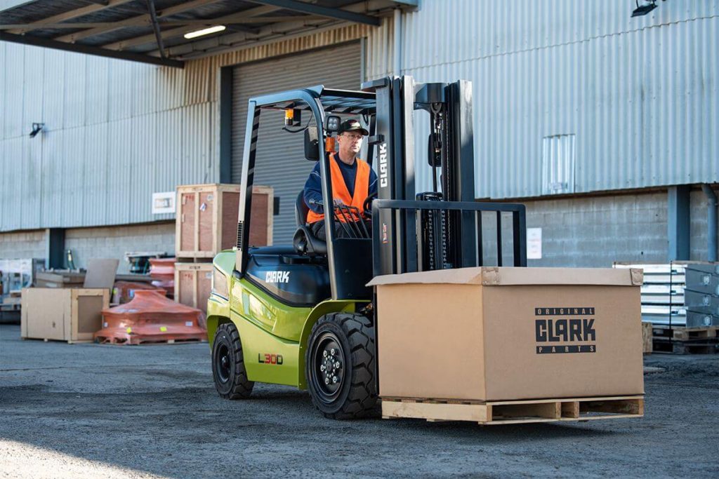 Clark forklift moving a boxed pallet outside a warehouse to show material handling costs affected by diesel prices